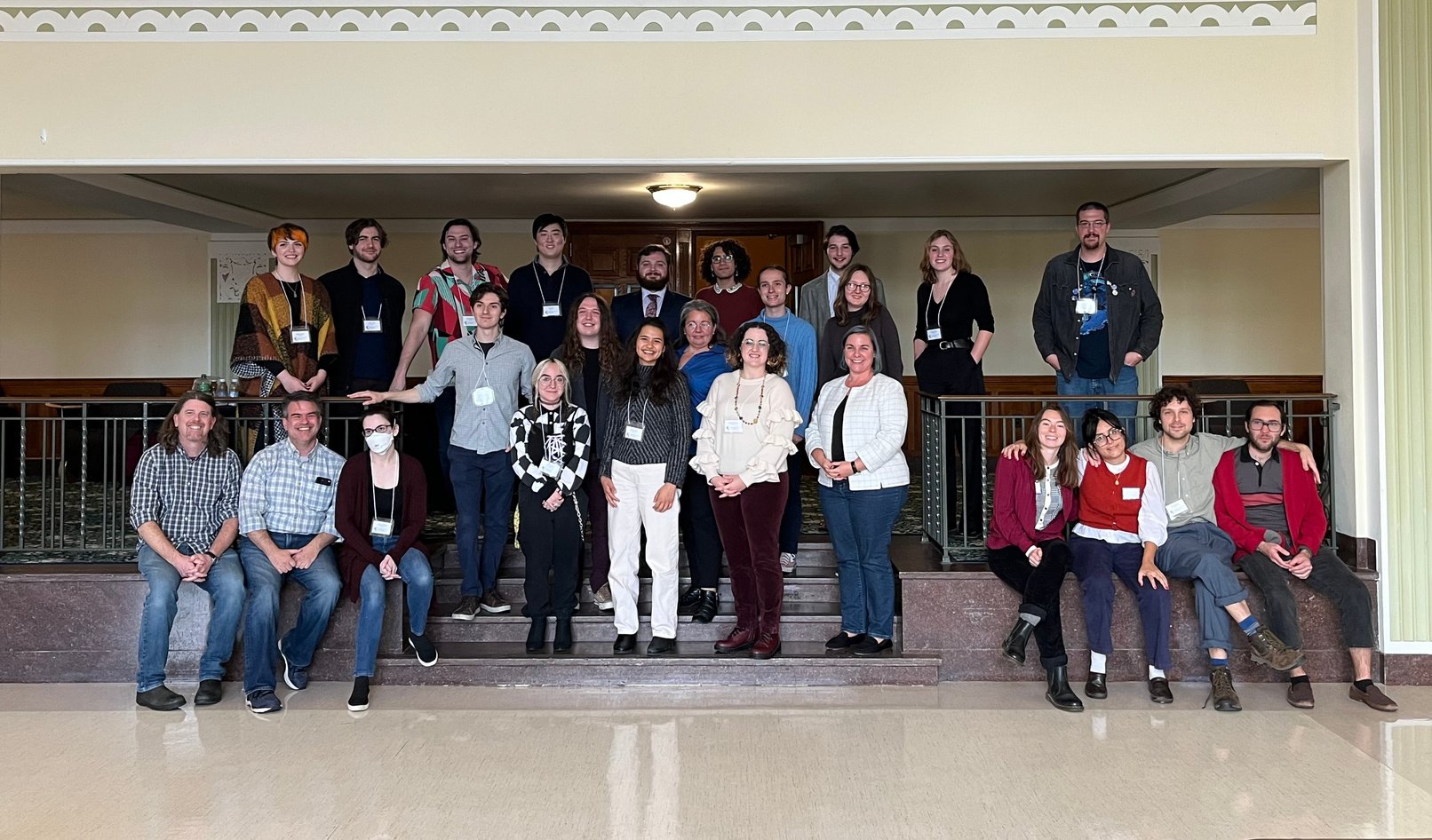 A group of attendees at the 14th annual UCIP pose for a photo inside a building.