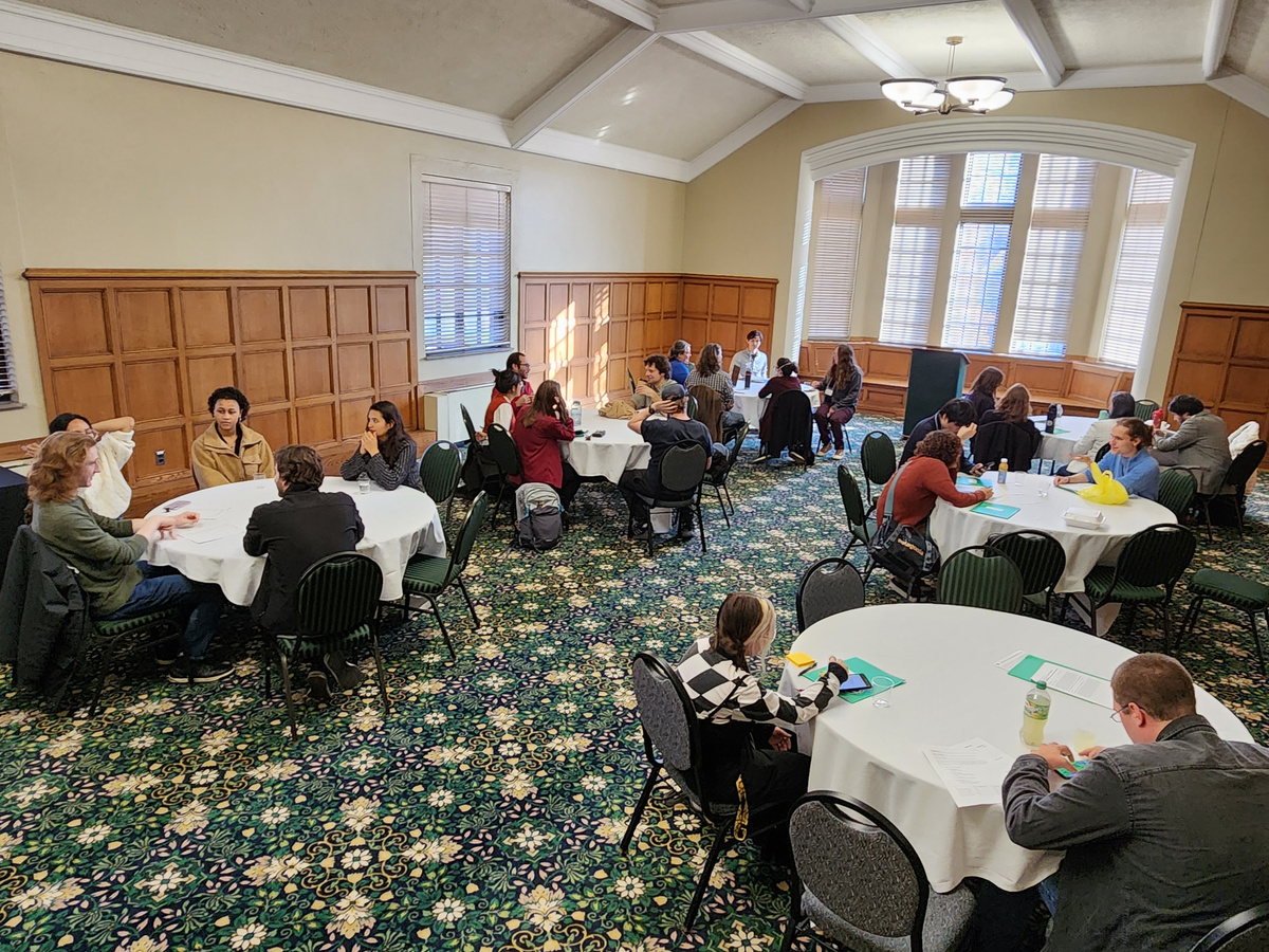 Attendees of UCiP sit and chat at round tables