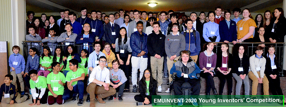 The emu inventeam posing for a photo in front of a building