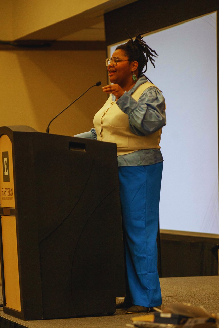 a person standing at a podium giving a presentation