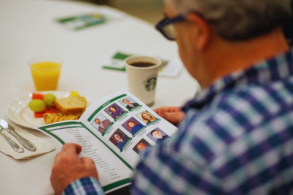 a person reading a program booklet 