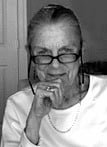 a black and white photo of an older person wearing glasses