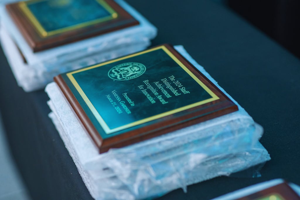 three plaques sitting on top of each other on a table