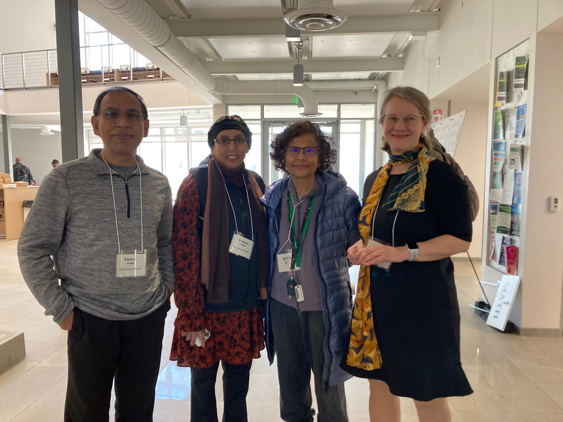 a group of people posing for a picture in a conference hall