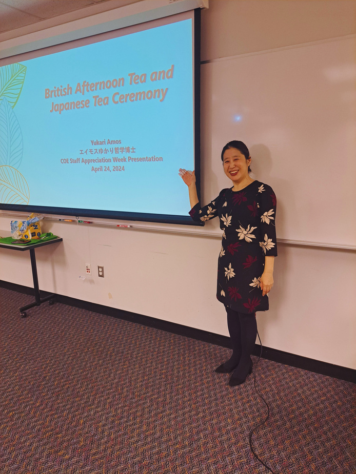 a person giving a presentation in front of a projector screen