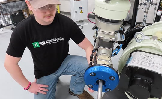 a person in a black shirt is working on a machine