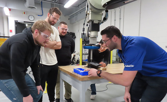 a group of people working on a project in a workshop