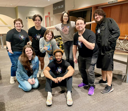 A full body group photo of eight members of the Theater for the Young.