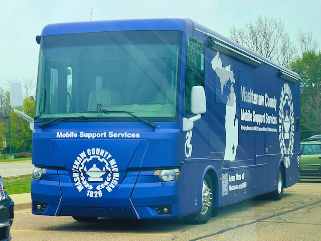 a blue bus with the words mobile support services on it