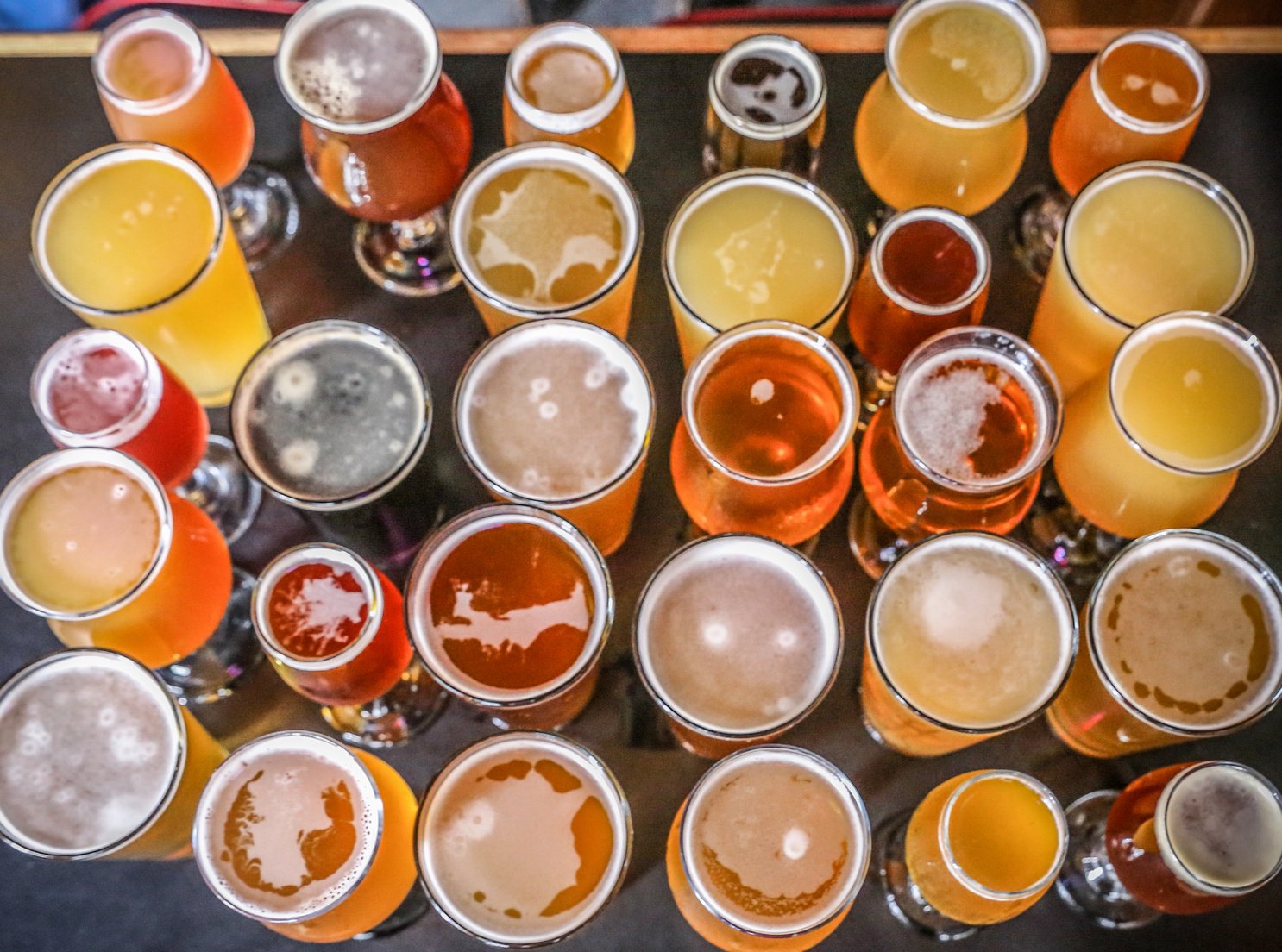 many different types of beer are lined up on a table