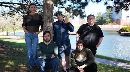 a group posing for a picture in front of a tree