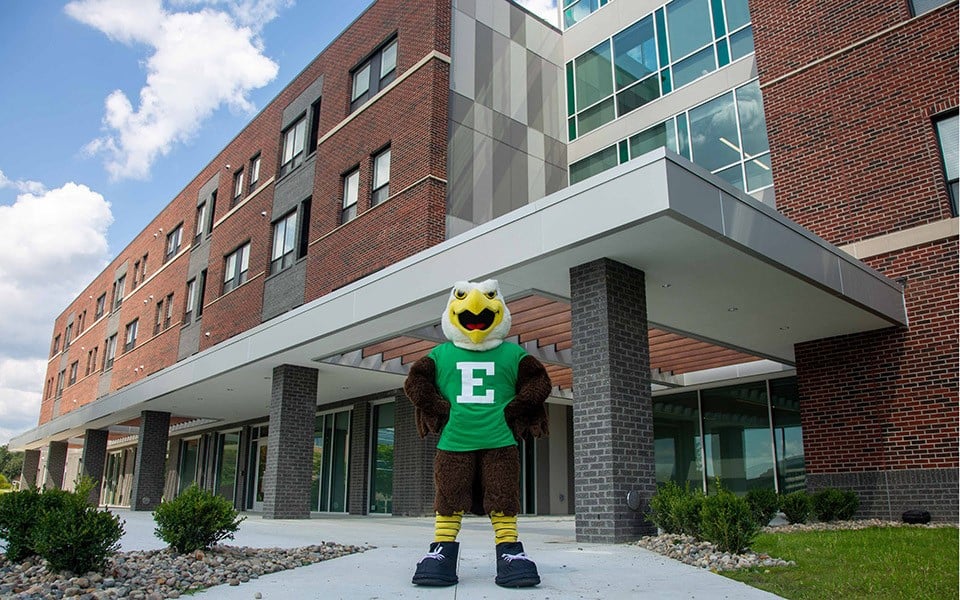 Swoop standing in front of the new EMU resident hall