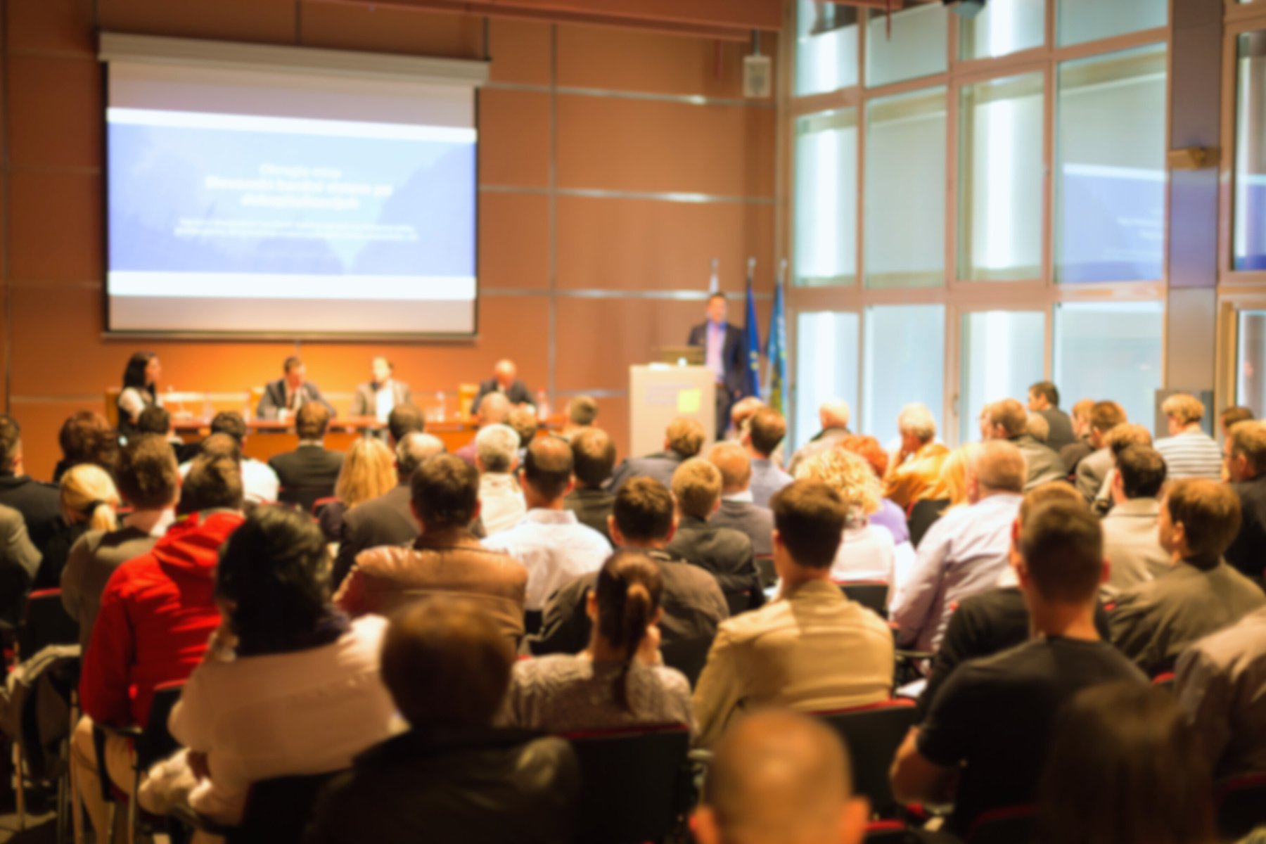 a crowd of people in a large auditorium