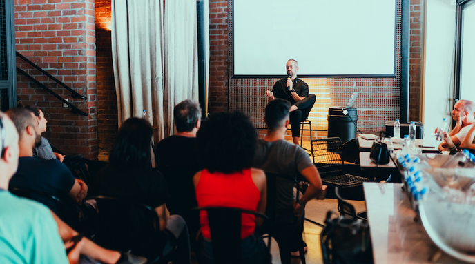 a man giving a presentation in front of a group of people