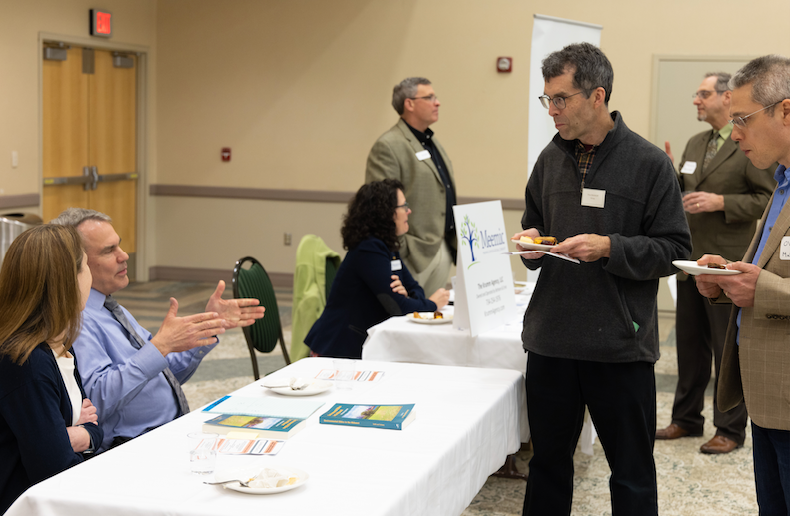 Faculty converse at a conference