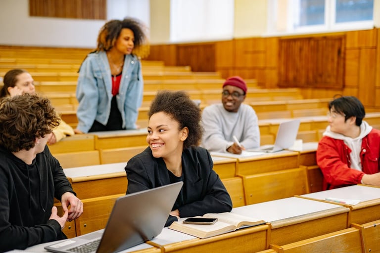 A group of people chat in a lecture hall